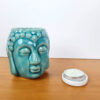 rechaud a base de vela com design de Buda