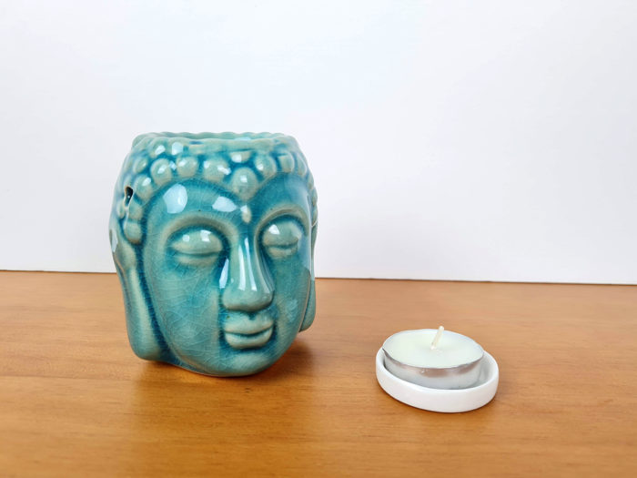 rechaud a base de vela com design de Buda