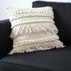 A Alma do Estilo Boho: Textura e Aconchego Existem peças que transformam instantaneamente a energia de um ambiente, e esta almofada balinesa é o exemplo perfeito. Com uma estética que transita entre o rústico chique e o estilo boho, ela se destaca pelo contraste sublime entre o tom cru-creme e a força do algodão trabalhado. Os Detalhes que Encantam: Trama Rica: O corpo da peça apresenta diferentes relevos, desde tranças encorpadas que trazem volume até faixas de pontos pipoca que convidam ao toque. Movimento das Franjas: As camadas de franjas desfiadas dão leveza e um ar despojado, quebrando a rigidez de qualquer móvel e trazendo um "movimento estático" muito elegante. Material Natural: Feita em algodão rústico, ela evoca a natureza e a simplicidade, proporcionando um conforto que vai além do visual — é um abraço em forma de decoração. No Décor Posicionada sobre um sofá de linho escuro, ela cria um contraste dramático e sofisticado. O preto do estofado serve como a moldura perfeita para que cada detalhe da trama clara ganhe vida, revelando a complexidade do trabalho manual. "É o toque final para quem busca um refúgio urbano com essência artesanal.