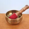 Tigela tibetana com 7 ligas de metal 14cm dourada de Buda