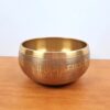 Tigela tibetana com 7 ligas de metal 14cm dourada de Buda