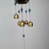 Sino dos ventos de metal com imagem de Ganesha e pedras de Olho Grego 55cm