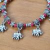 Pulseira de prata alemã com elefantinhos e contas vermelhas